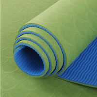 rolled green and blue TPE yoga mat