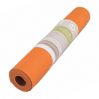rolled orange and white TPE yoga mat