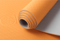 rolled orange TPE yoga mat for easy storage