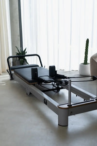 Foldable Pilates reformer machine with carriage and frame